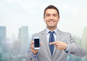 Image showing happy businessman showing smartphone screen