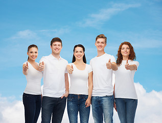 Image showing smiling teenagers in t-shirts showing thumbs up