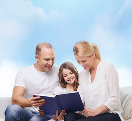 Image showing happy family with book at home