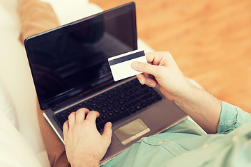 Image showing close up of man with laptop and credit card