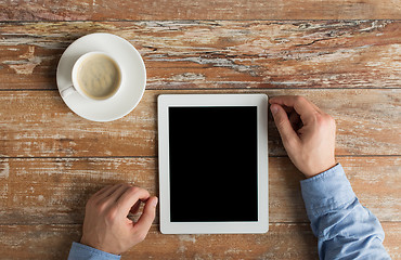 Image showing close up of male hands with tablet pc and coffee