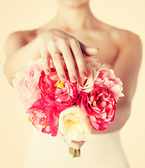 Image showing bride with bouquet of flowers and wedding ring