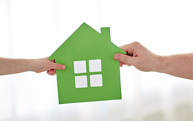 Image showing close up of child and father hands with house