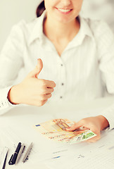 Image showing woman hands with euro cash money and thumbs up