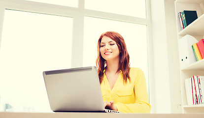 Image showing businesswoman with laptop computer in office