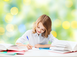 Image showing happy girl with books and notebook at school