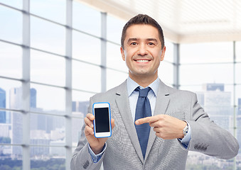 Image showing happy businessman showing smartphone screen