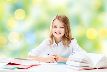 Image showing happy girl with books and notebook at school