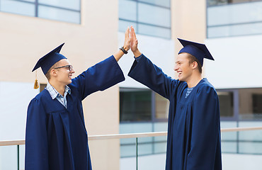 Image showing smiling students in mortarboards