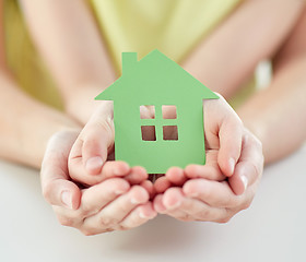 Image showing close up of woman and girl hands with paper house