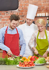 Image showing happy couple and male chef cook cooking in kitchen