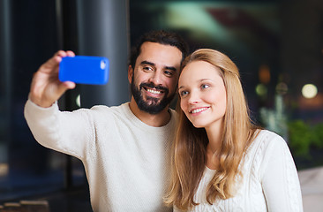 Image showing happy couple with tablet pc and coffee at cafe