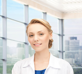 Image showing smiling young female doctor in white coat