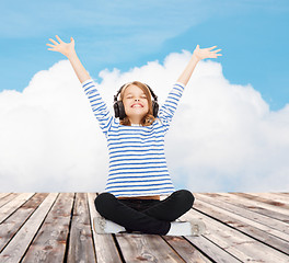 Image showing happy girl with headphones listening to music