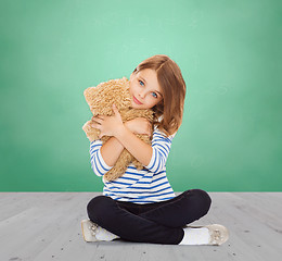 Image showing cute little girl hugging teddy bear