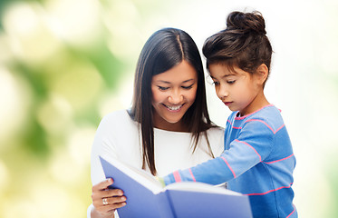 Image showing happy mother and daughter reading book