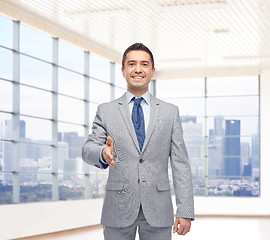 Image showing happy smiling businessman in suit shaking hand