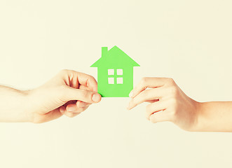 Image showing couple hands holding green house