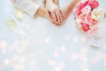 Image showing close up of lesbian couple hands and wedding rings