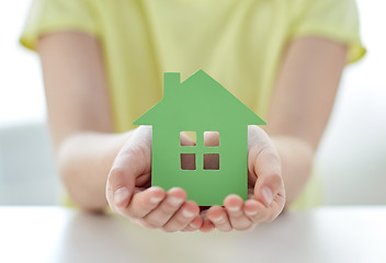 Image showing close up of happy girl hands holding paper house