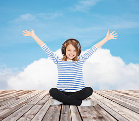 Image showing happy girl with headphones listening to music