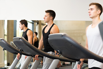 Image showing group of men exercising on treadmill in gym