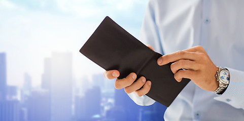 Image showing close up of businessman hands holding open wallet