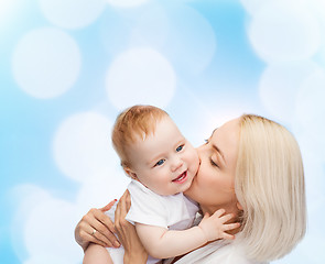 Image showing happy mother kissing smiling baby