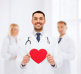 Image showing smiling male doctor with red heart