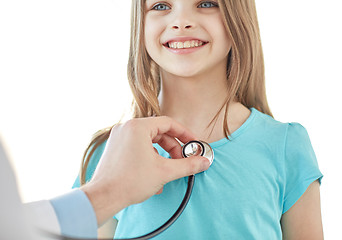 Image showing close up of happy girl and doctor on medical exam