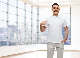 Image showing smiling man in t-shirt pointing finger on himself