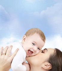 Image showing laughing baby playing with mother