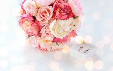 Image showing close up of two wedding rings and flower bunch