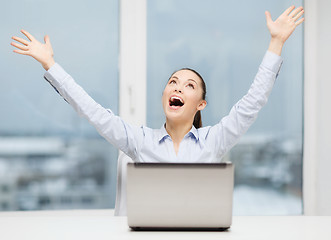 Image showing screaming businesswoman with laptop in office