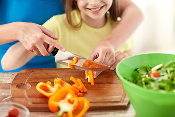 Image showing close up of happy family making dinner in kitchen