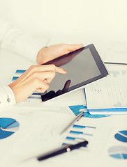 Image showing woman with tablet pc and chart papers