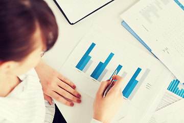 Image showing woman hand with charts and papers