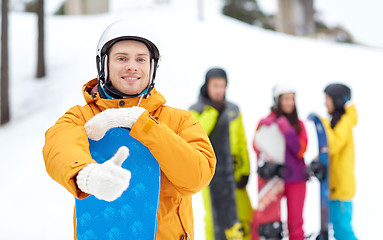 Image showing happy young man with snowboard showing thumbs up