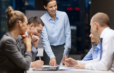 Image showing smiling female boss talking to business team