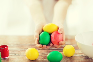 Image showing close up of girl holding colored eggs