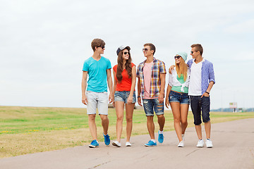 Image showing group of smiling teenagers walking outdoors