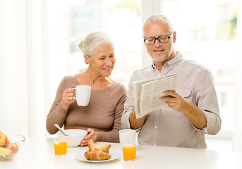 Image showing happy senior couple having breakfast at home