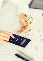 Image showing woman hand with calculator and euro money