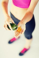 Image showing woman hand with capsules