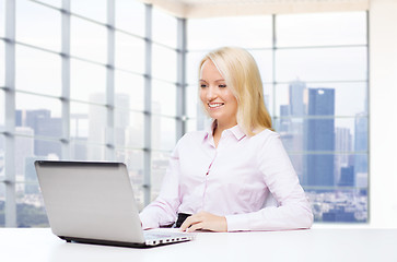 Image showing smiling businesswoman or student with laptop