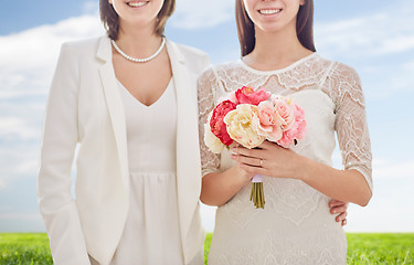 Image showing close up of happy lesbian couple with flowers