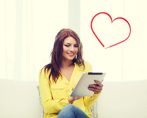 Image showing smiling woman with tablet pc computer at home