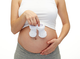 Image showing close up of pregnant woman with babys bootees