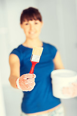 Image showing woman with paintbrush and paint pot