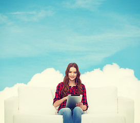 Image showing teenage girl sitting on sofa with tablet pc